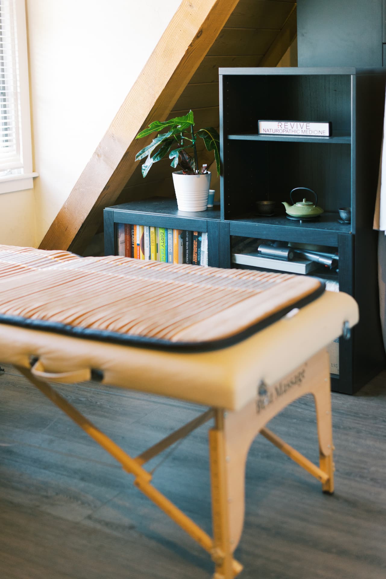 Treatment room with Revive Naturopathic Medicine signage