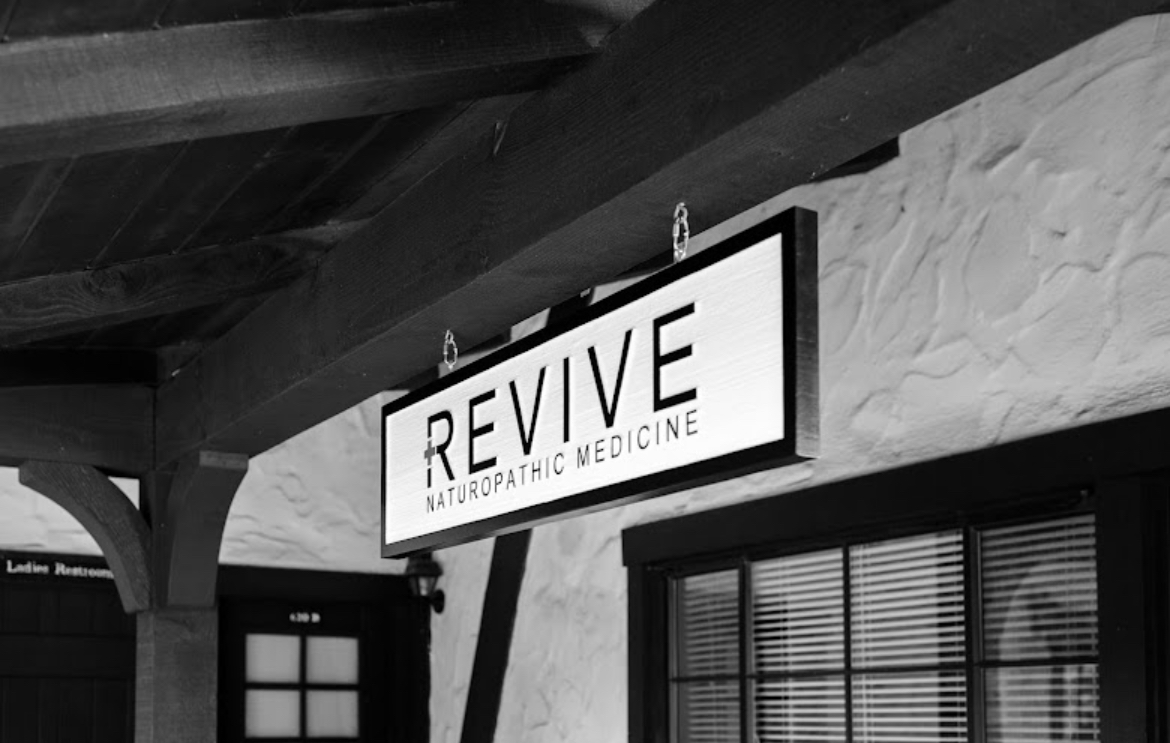Hanging Revive Naturopathic Medicine sign at the entrance